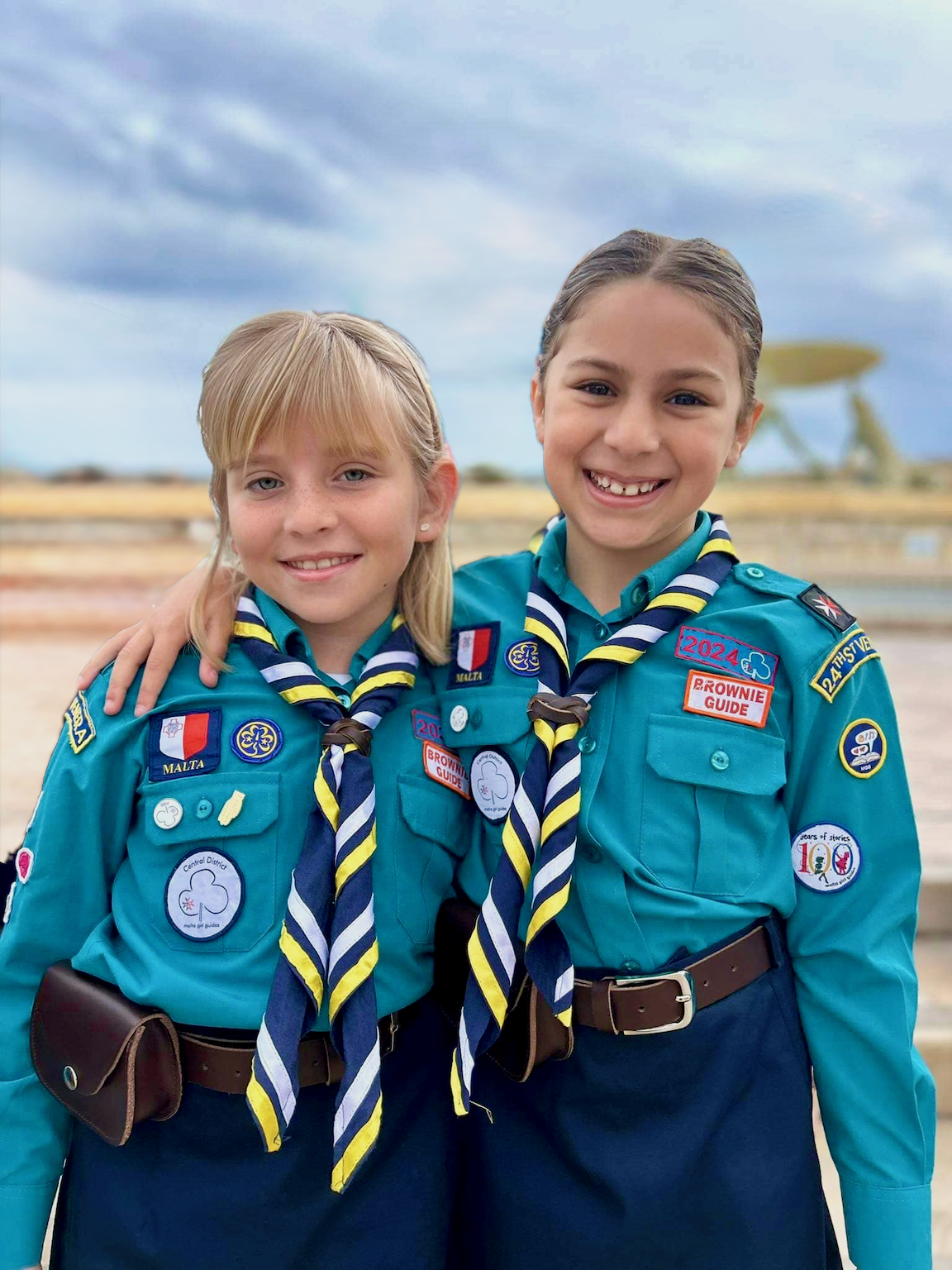 Girl Guides marching together along a Maltese street